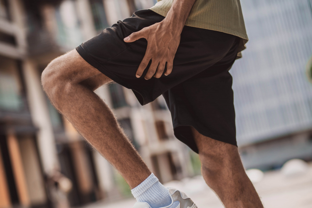 close-up-man-holding-his-leg-its-upper-part (1).jpg
