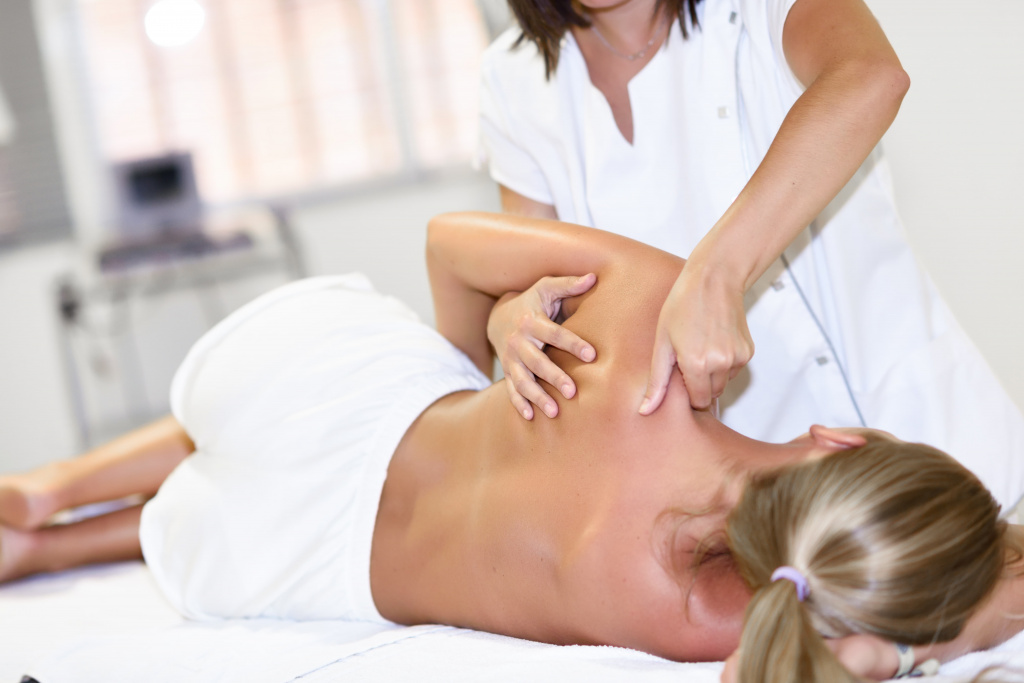professional-female-physiotherapist-giving-shoulder-massage-blonde-woman (1).jpg