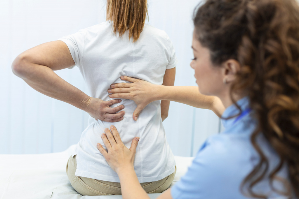 physiotherapist-doing-healing-treatment-womans-back-back-pain-patient-treatment-medical-doctor-massage-therapistoffice-syndrome (1).jpg