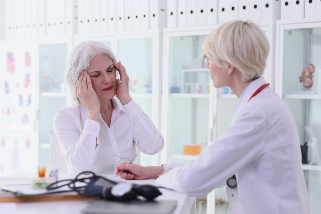 old-woman-complains-strong-migraine-doctor-hospital-cabinet-lady-therapist-listens (1).jpg
