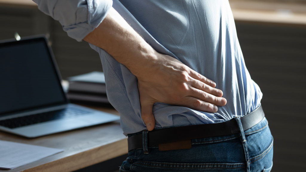 crop-close-up-man-sit-desk-work-laptop-touch-back-suffer-from-muscular-spasm-from-sedentary-lifestyle-unwell-male-struggle-with-painful-feeling-have-radiculitis-health-problem-concept (1).jpg